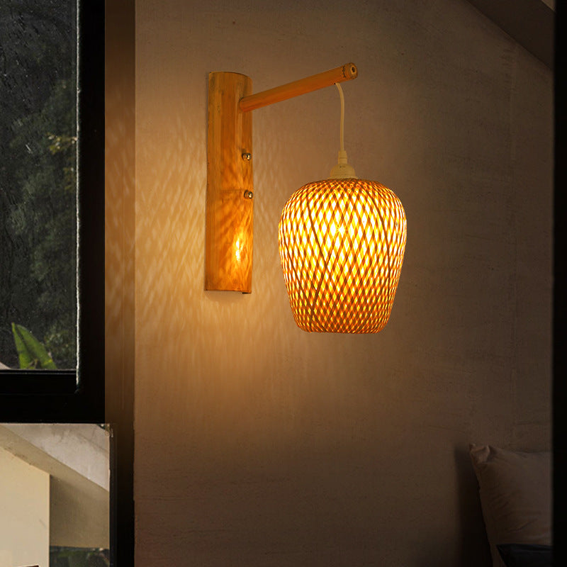 Hayami egg wall lamp featuring a woven bamboo shade hanging from a wooden wall bracket.  