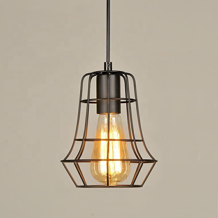 A matte black metal cage pendant light with an exposed Edison-style filament bulb glowing warm orange.