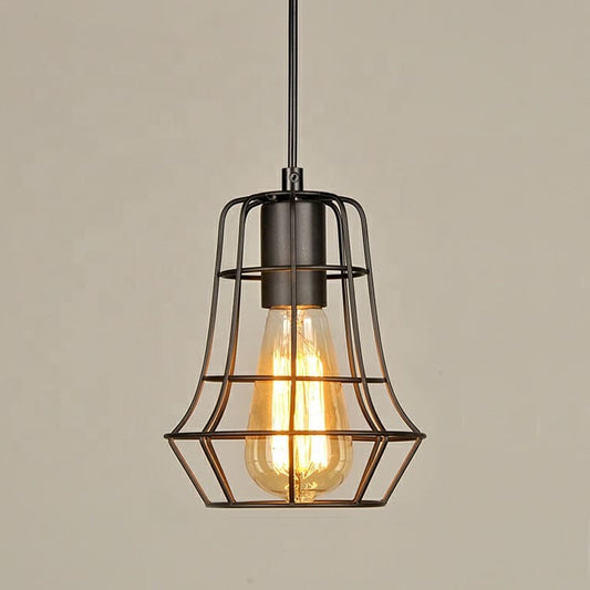 A matte black metal cage pendant light with an exposed Edison-style filament bulb glowing warm orange.
