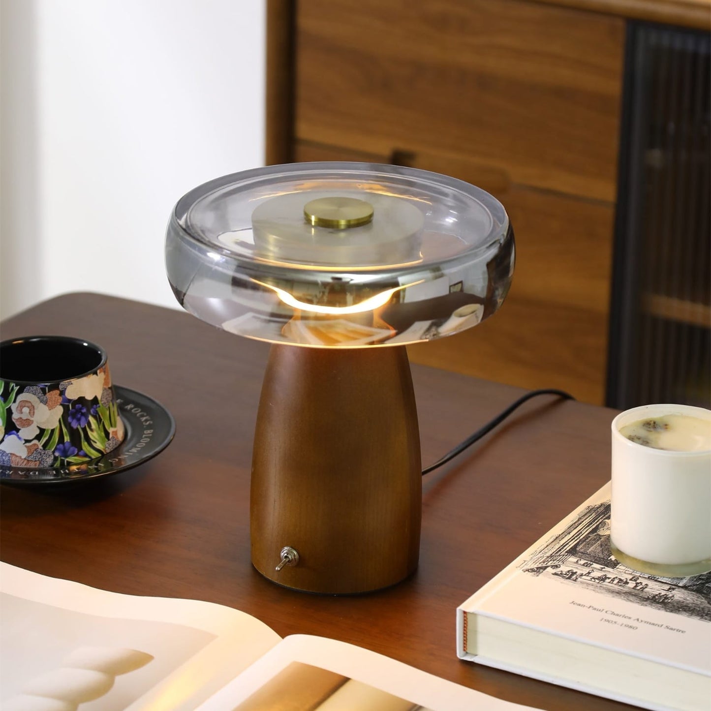 Smoked glass dome table lamp with dark wood base on desk