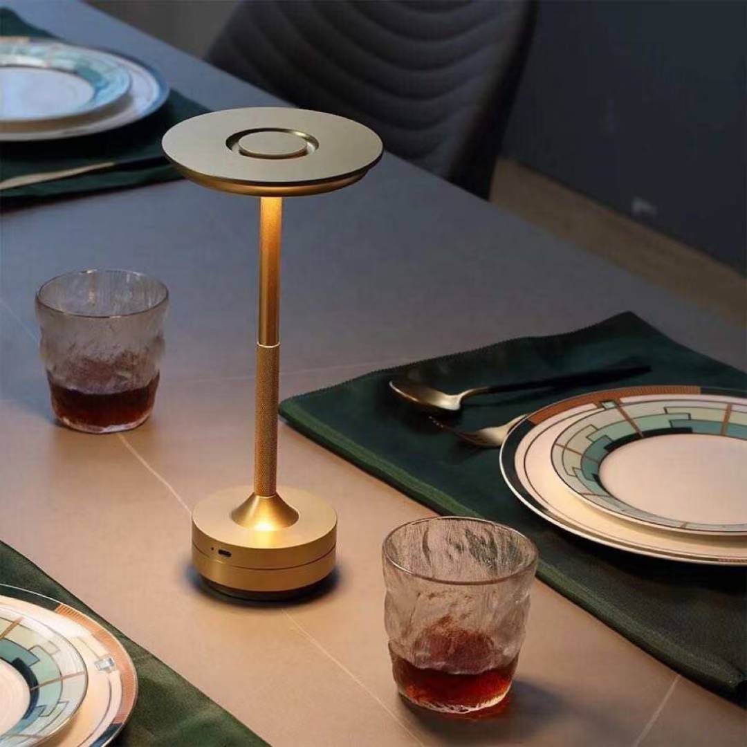 Rechargeable led table lamp on a dining table with plates and glasses