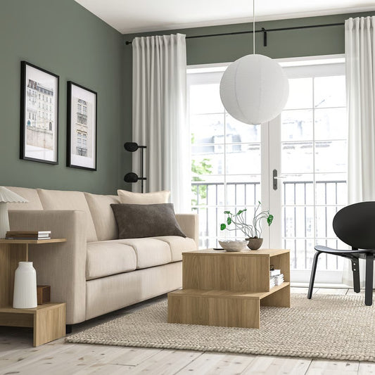 white round paper pendant light suspended in a living room